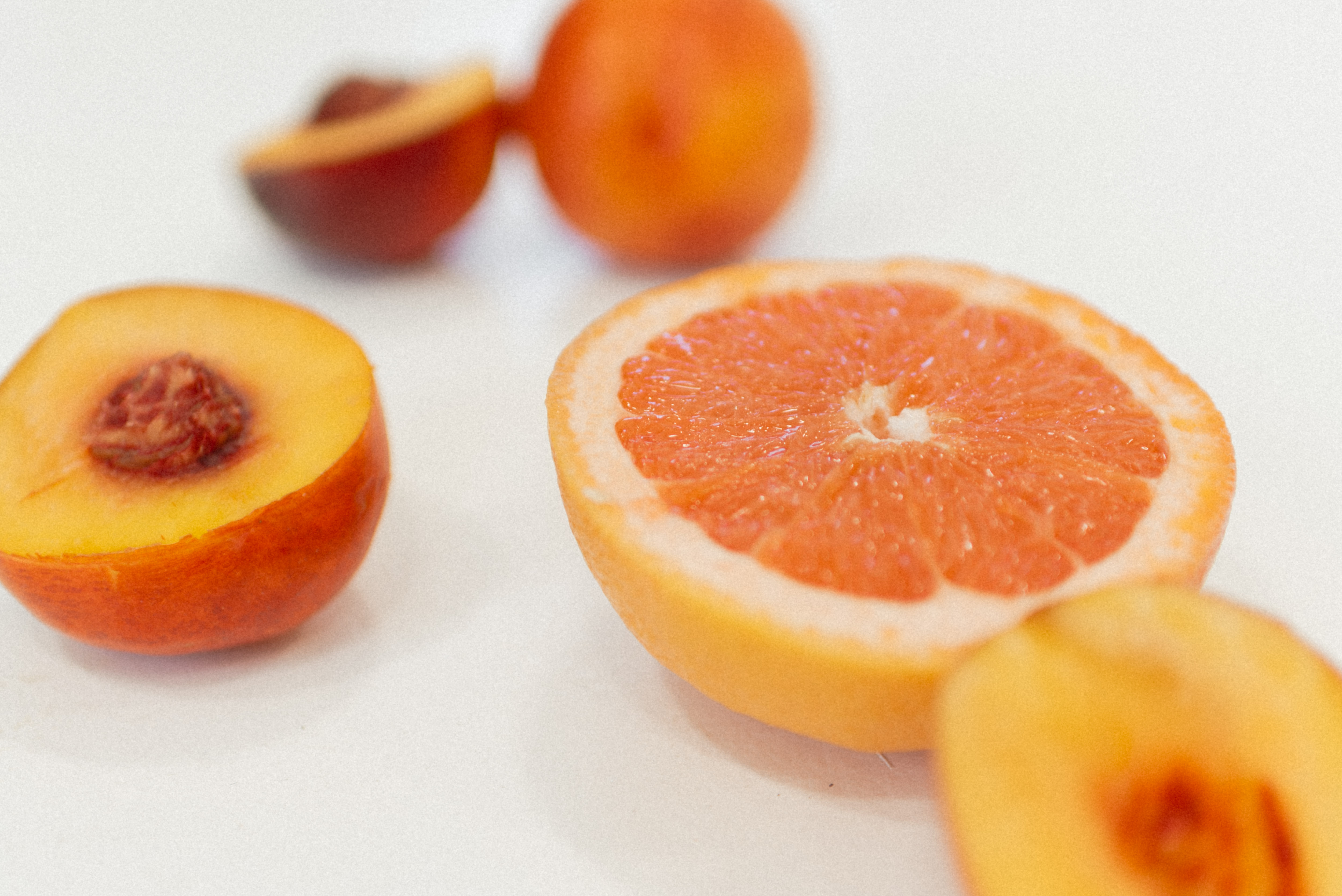 Fresh peach and grapefruit slices symbolizing smooth skin after Brazilian waxing in Sandy UT